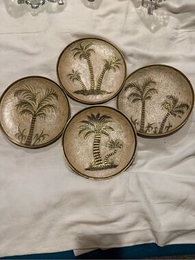 vintage-style plates are made from solid brass with an enamel palm tree design